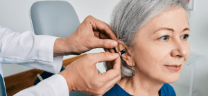 Woman getting fitted with hearing aids at New River Valley Hearing