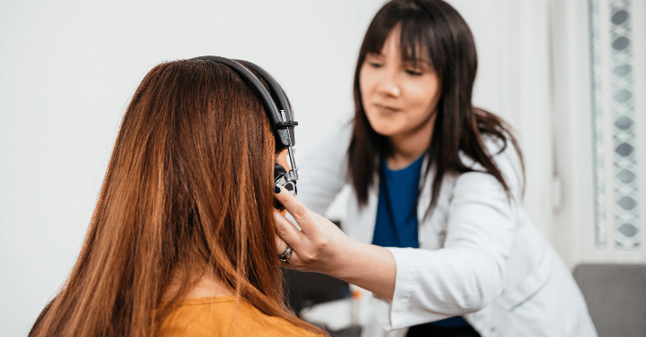 Audiologist giving a hearing exam to patient in Radford, VA